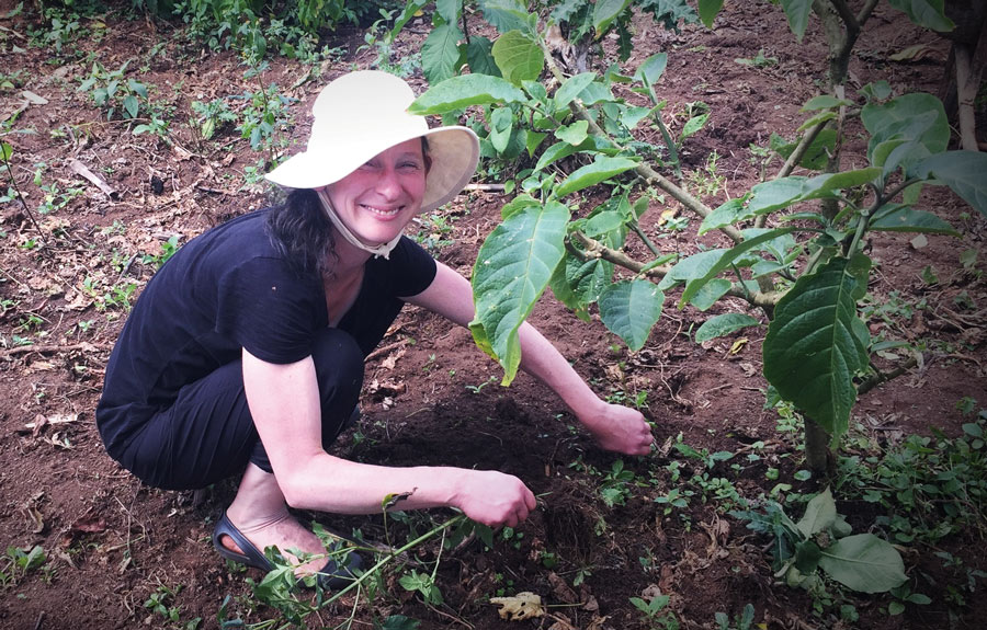 Marianne Staniunas gets her hands  in the soil  during one of  her annual visits to Uganda