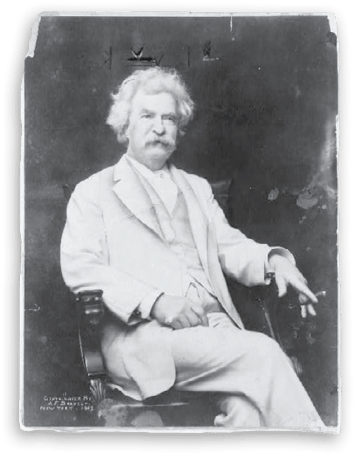 black and white photograph of Mark Twain seated while wearing his iconic white suit